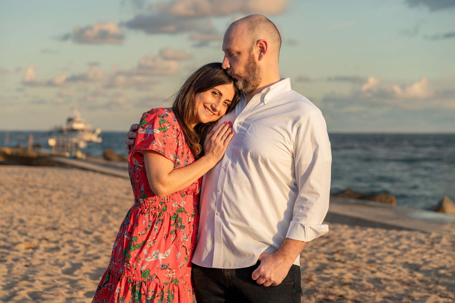 Romantic couple’s beach photoshoot in Palm Beach, FL – soft sunset light and ocean waves creating a dreamy atmosphere.