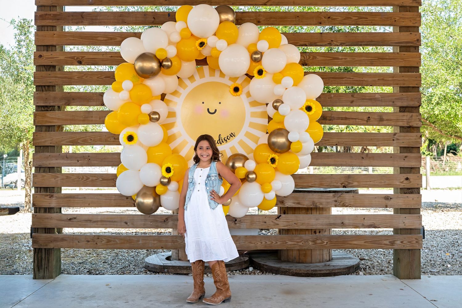 Birthday portrait of girl in front of balloon arch at Berry Farms, part of a South Florida birthday session.