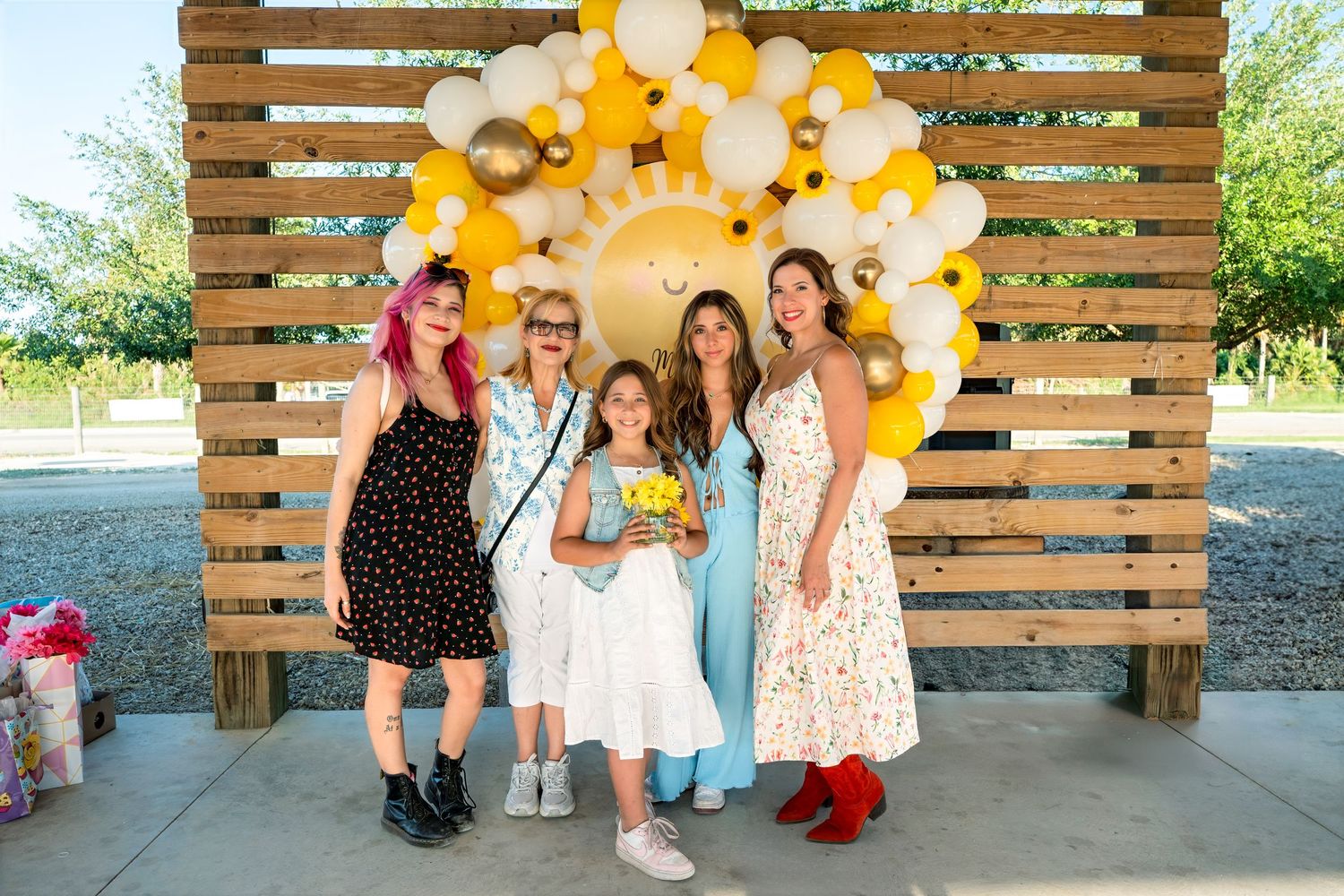 Family posing at Berry Farms birthday party, South Florida lifestyle event session.