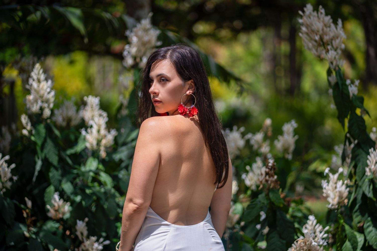 Woman posing among flowers during portrait session at Mounts Botanical Garden in Florida