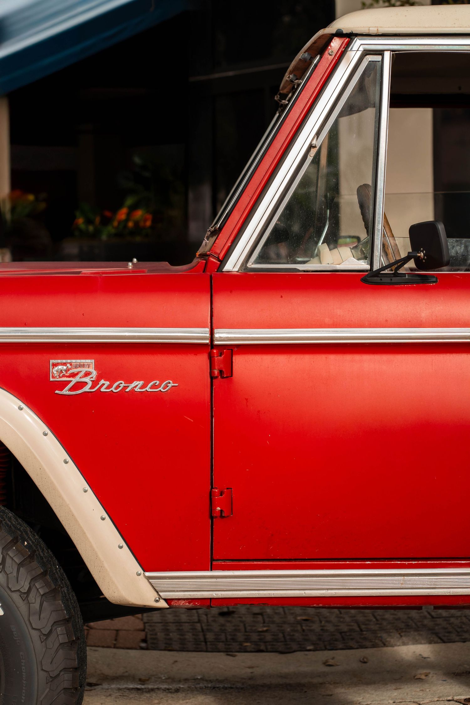 Vintage Ford Bronco in Miami, FL – classic red truck parked in an urban setting with warm sunlight.