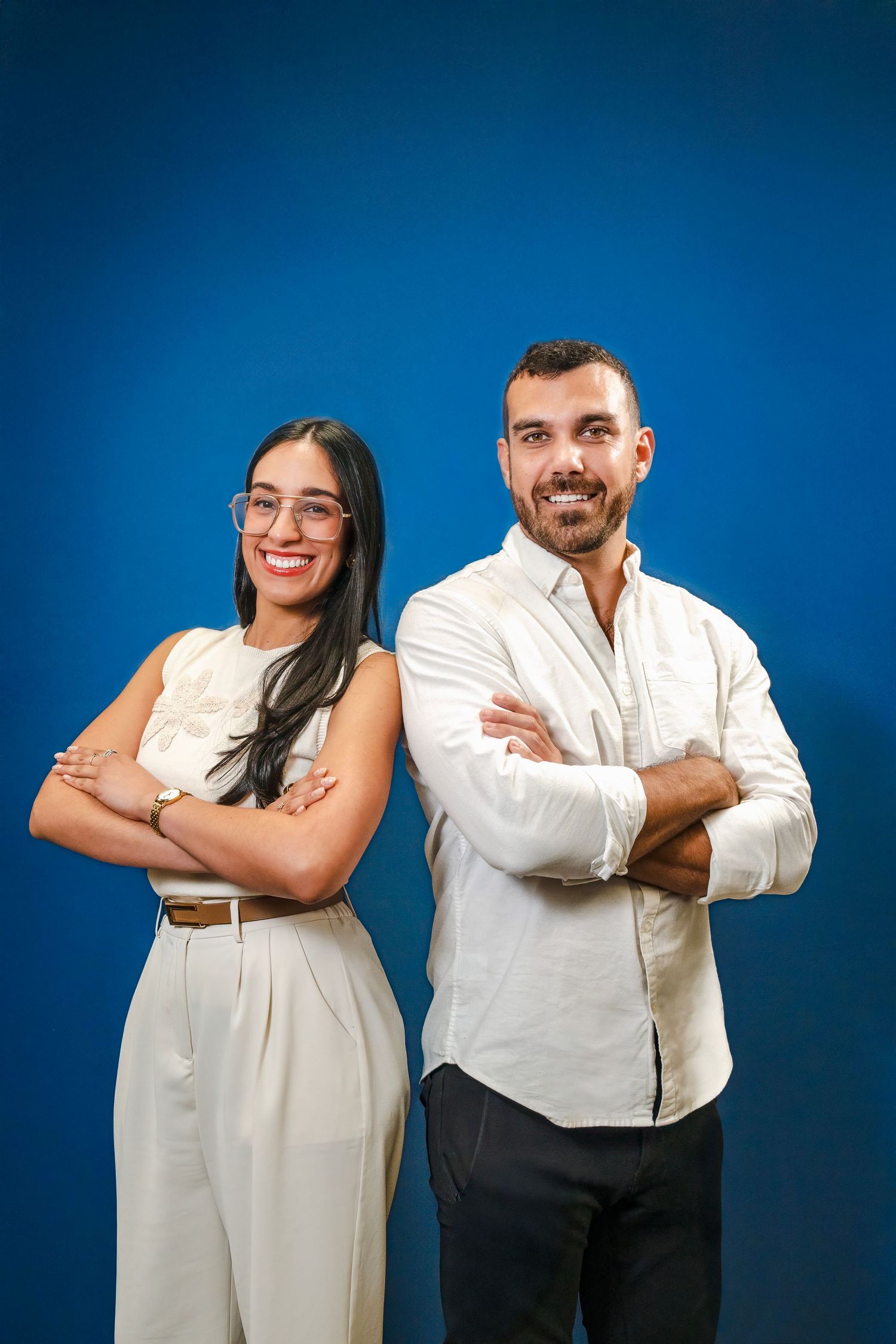 Chiropractor team posing against blue backdrop during branding session in South Florida