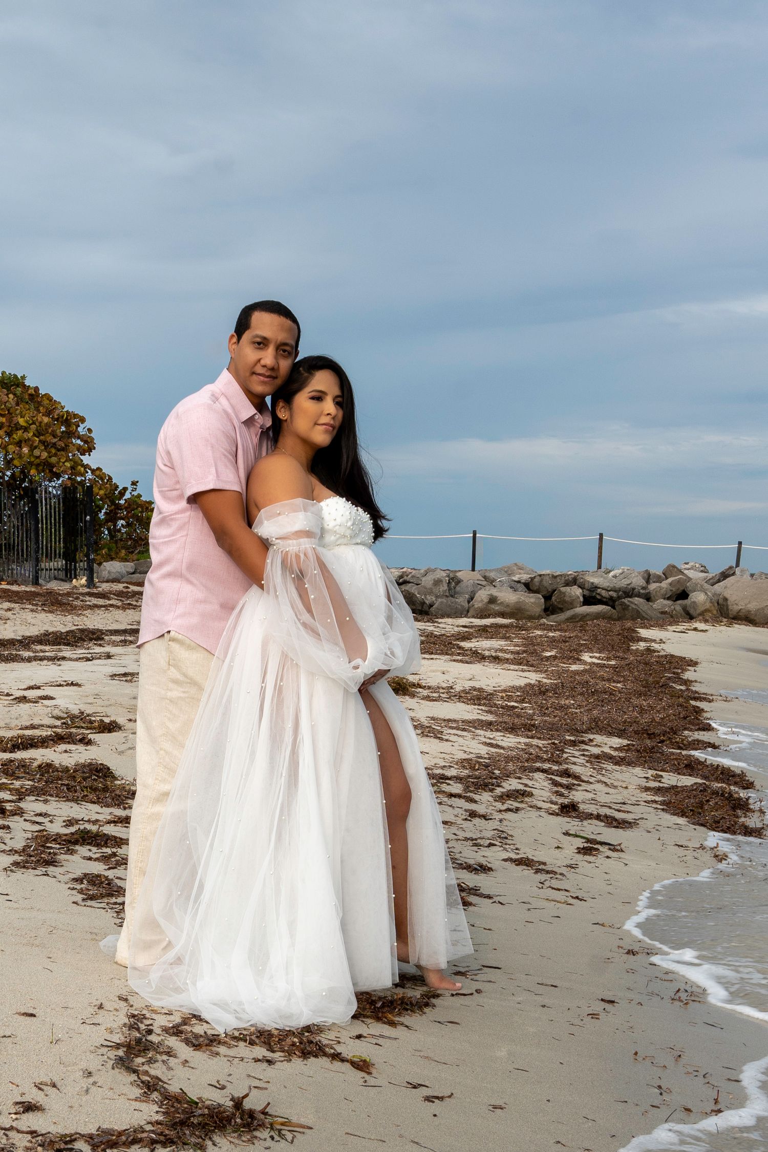 Elegant maternity session in Key Biscayne, capturing a peaceful moment as a mother-to-be embraces the coastal breeze.