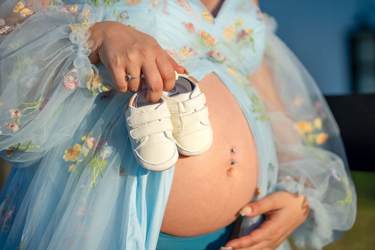 Close-up of baby bump with tiny shoes, taken during South Florida maternity sessi