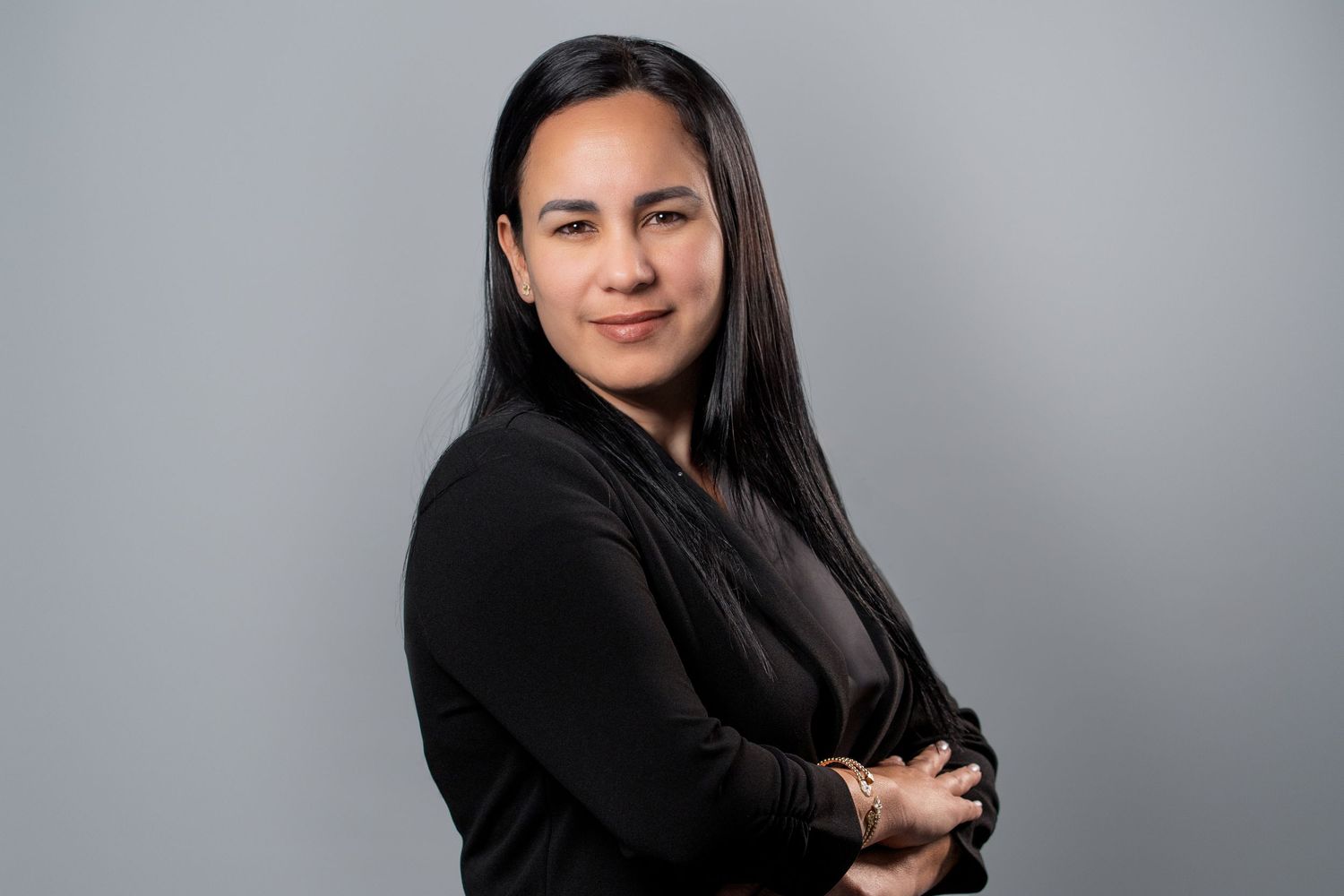Woman in black outfit posing for studio professional headshot