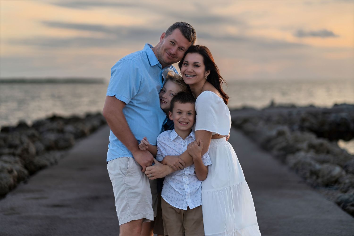 Sunset family portrait on the rocks at Key Biscayne, Florida.