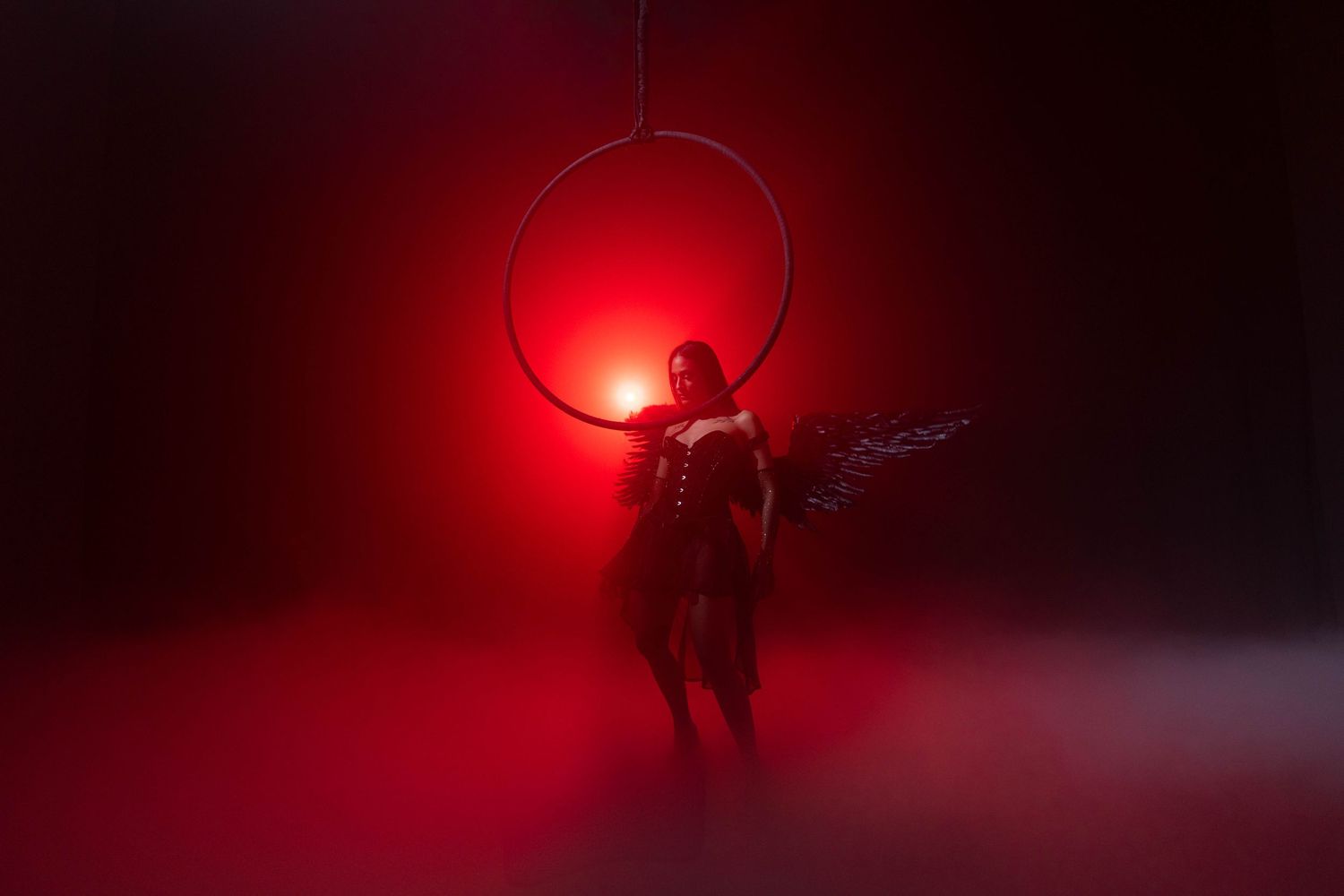 Dramatic high-concept photography at CFX Studio, Miami, FL – ethereal aerial performance in a glowing red-hued environment.