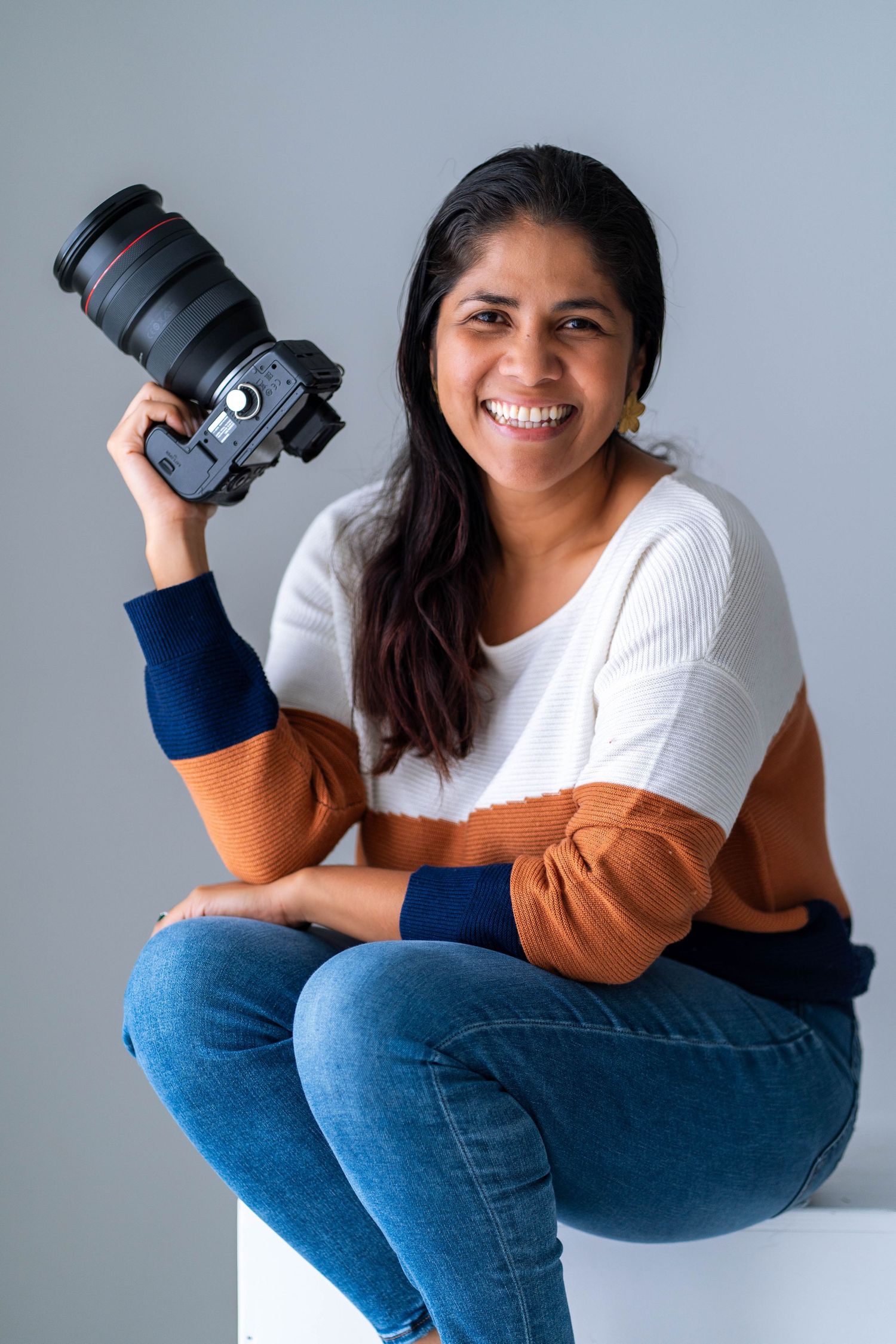 Empowered photographer portrait in Fort Lauderdale, FL – joyful and confident moment with a camera in hand.