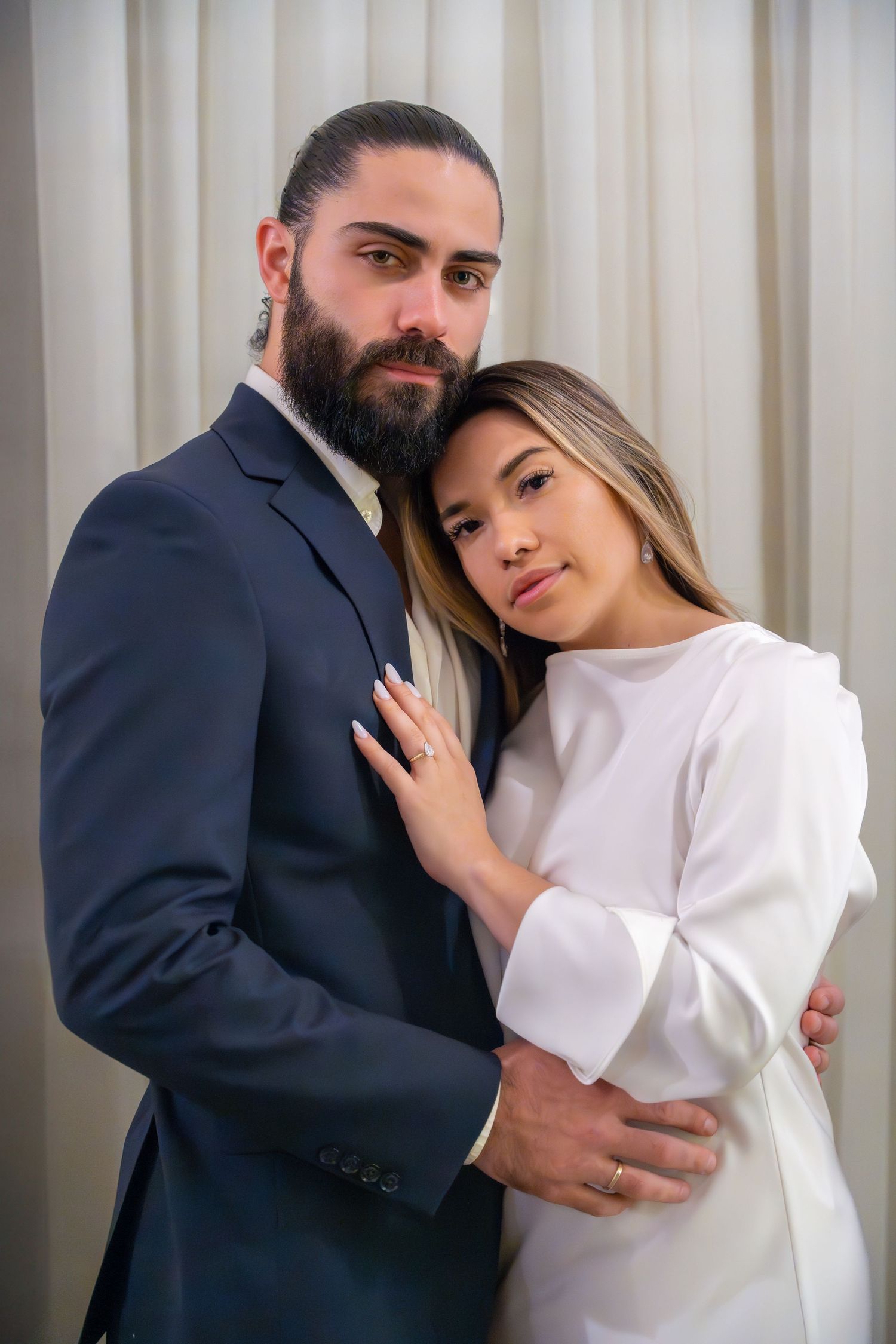 Classic engagement portrait featuring a couple in elegant attire, captured in a timeless indoor setting. Worth Ave Palm Beach