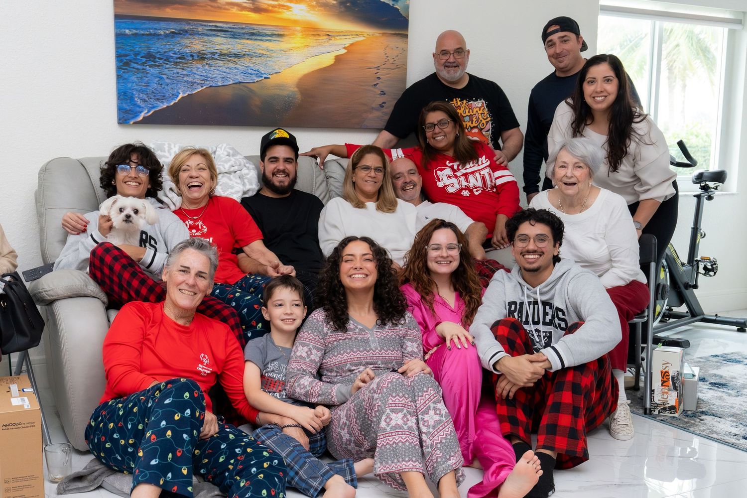 Multi-generational family group photo indoors, candid and joyful lifestyle family photography.
