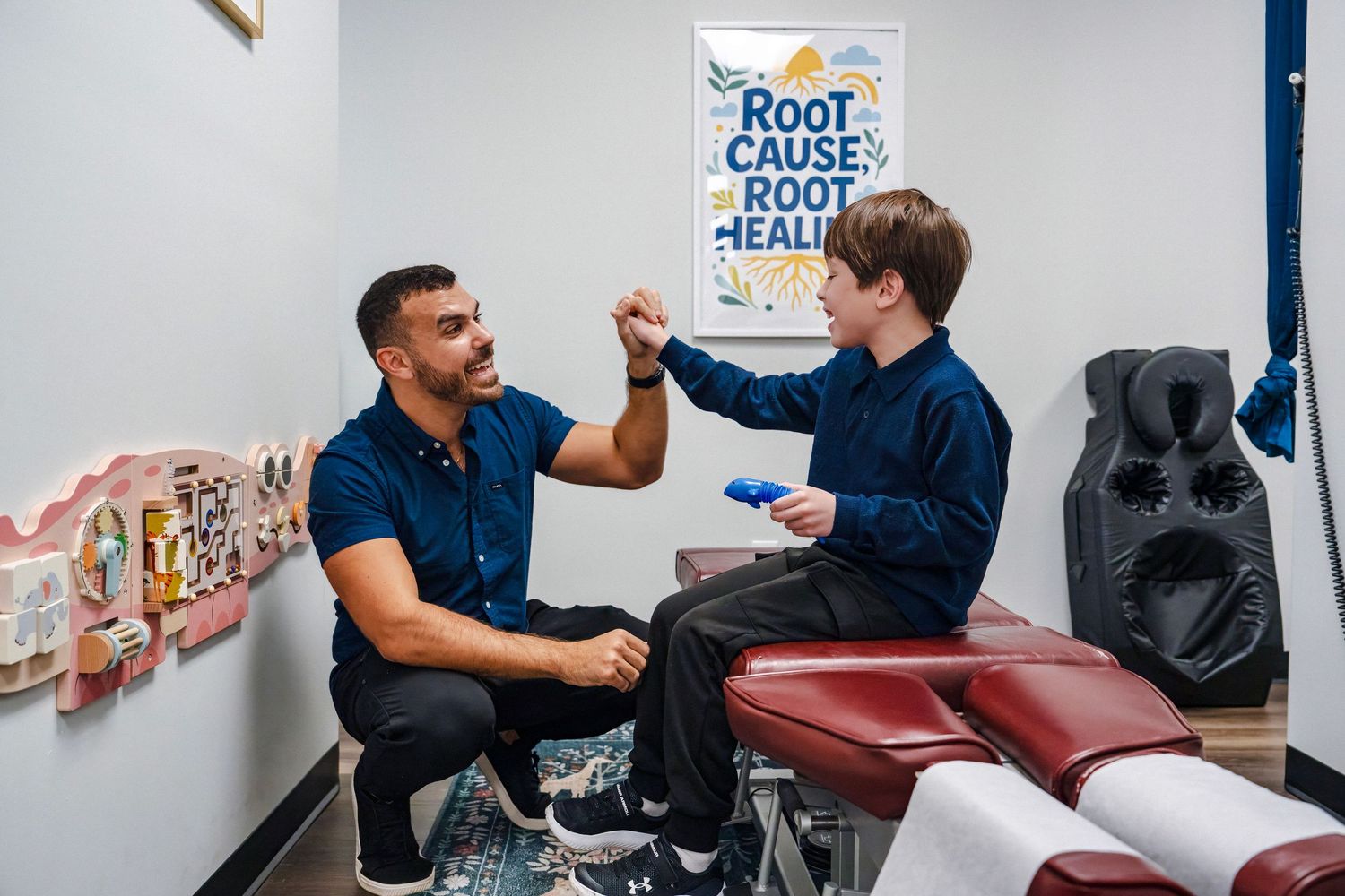 Chiropractor working with patient during branding session in clinic