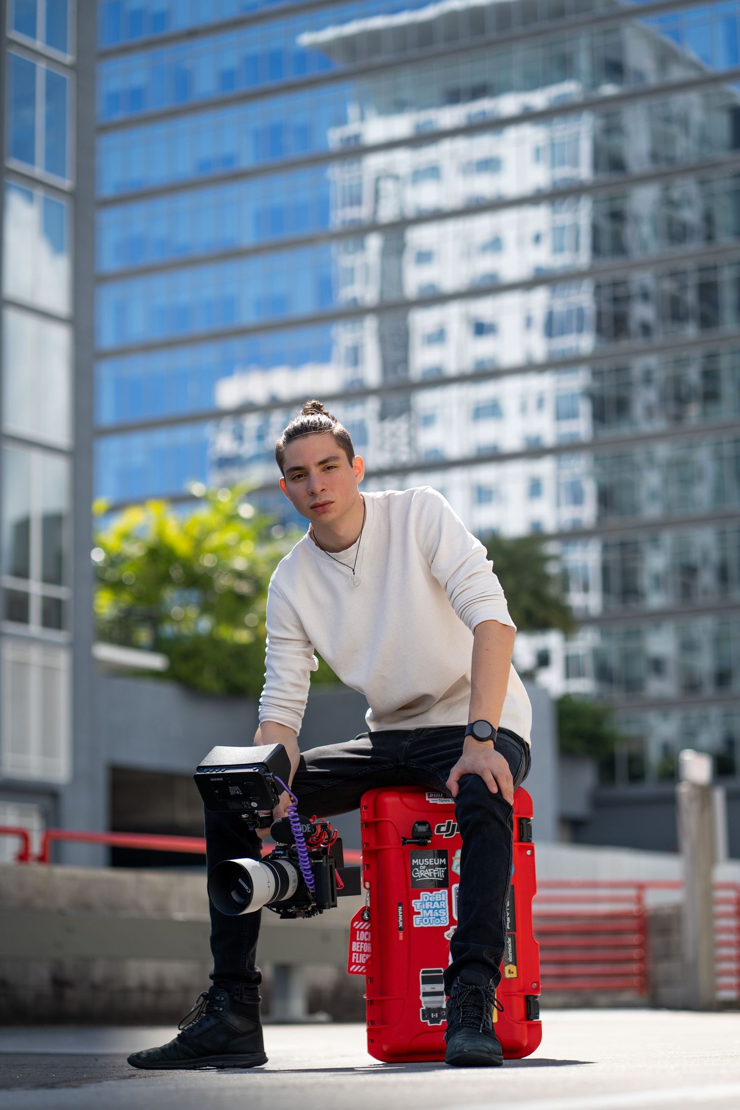 Urban branding portrait of photographer with Nanuk gear in front of glass building in Fort Lauderdale.