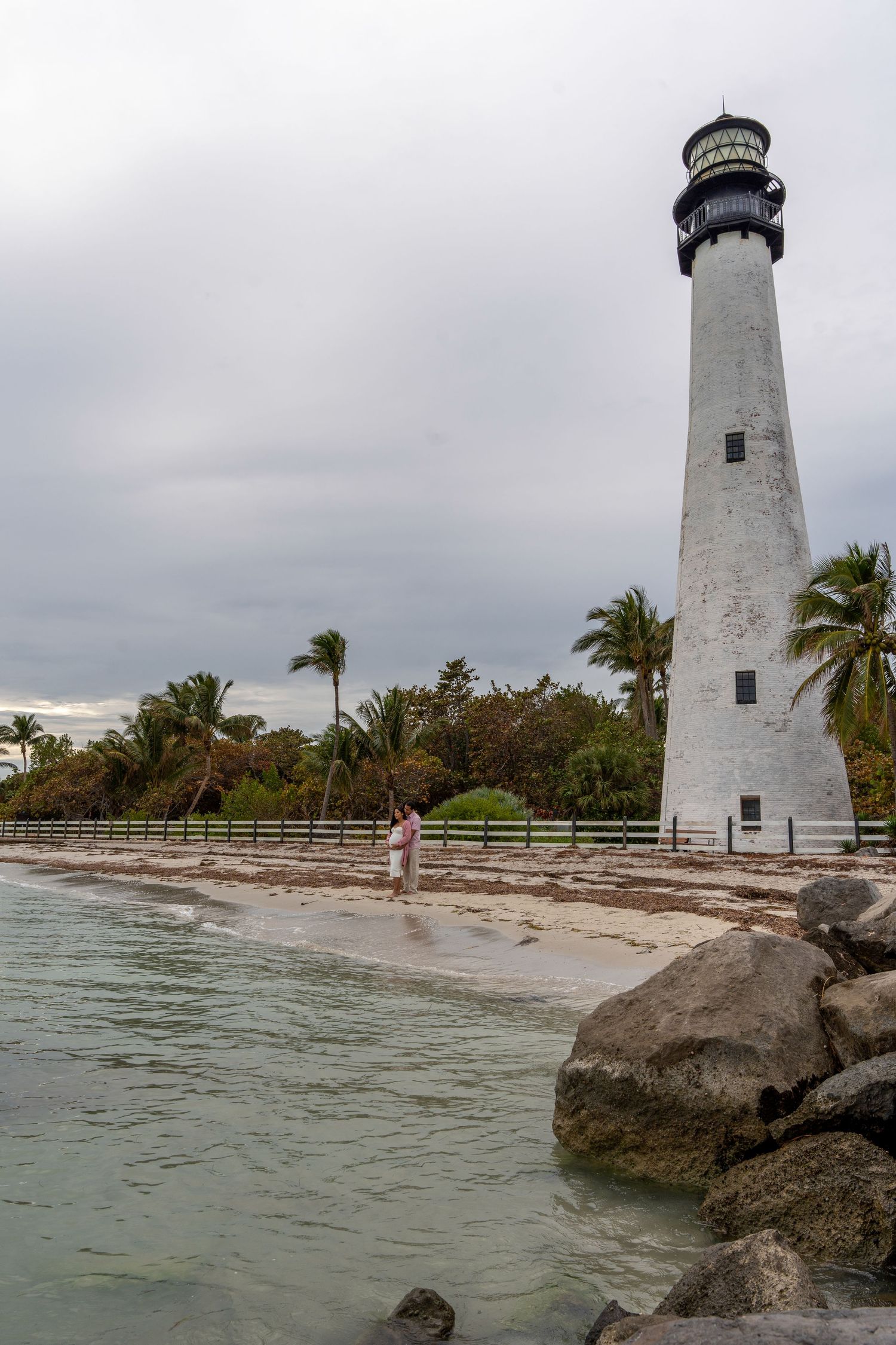 Scenic maternity session at Cape Florida Lighthouse, capturing love, history, and the beauty of Florida’s coastline.