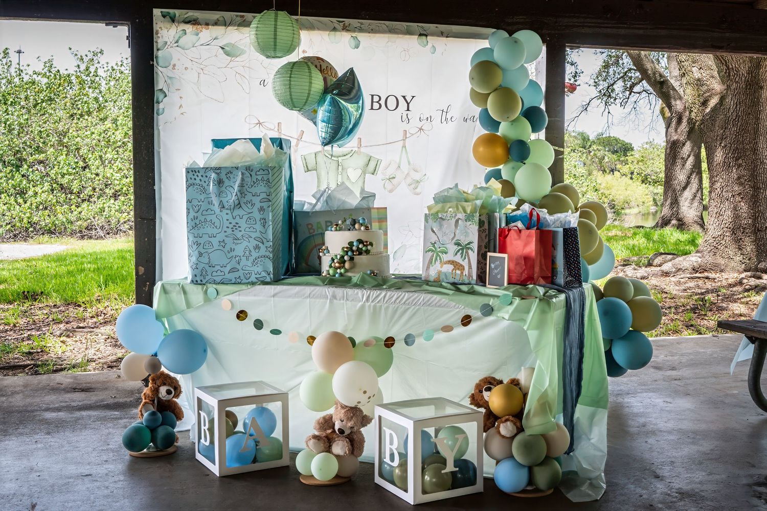 Styled baby shower dessert table with themed decorations and gifts at a South Florida event.
