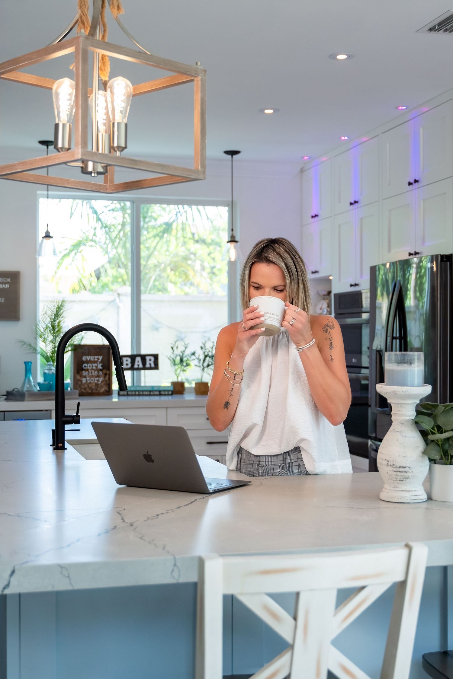Entrepreneur lifestyle session in Fort Lauderdale, FL – relaxed morning coffee moment in a bright, modern kitchen.