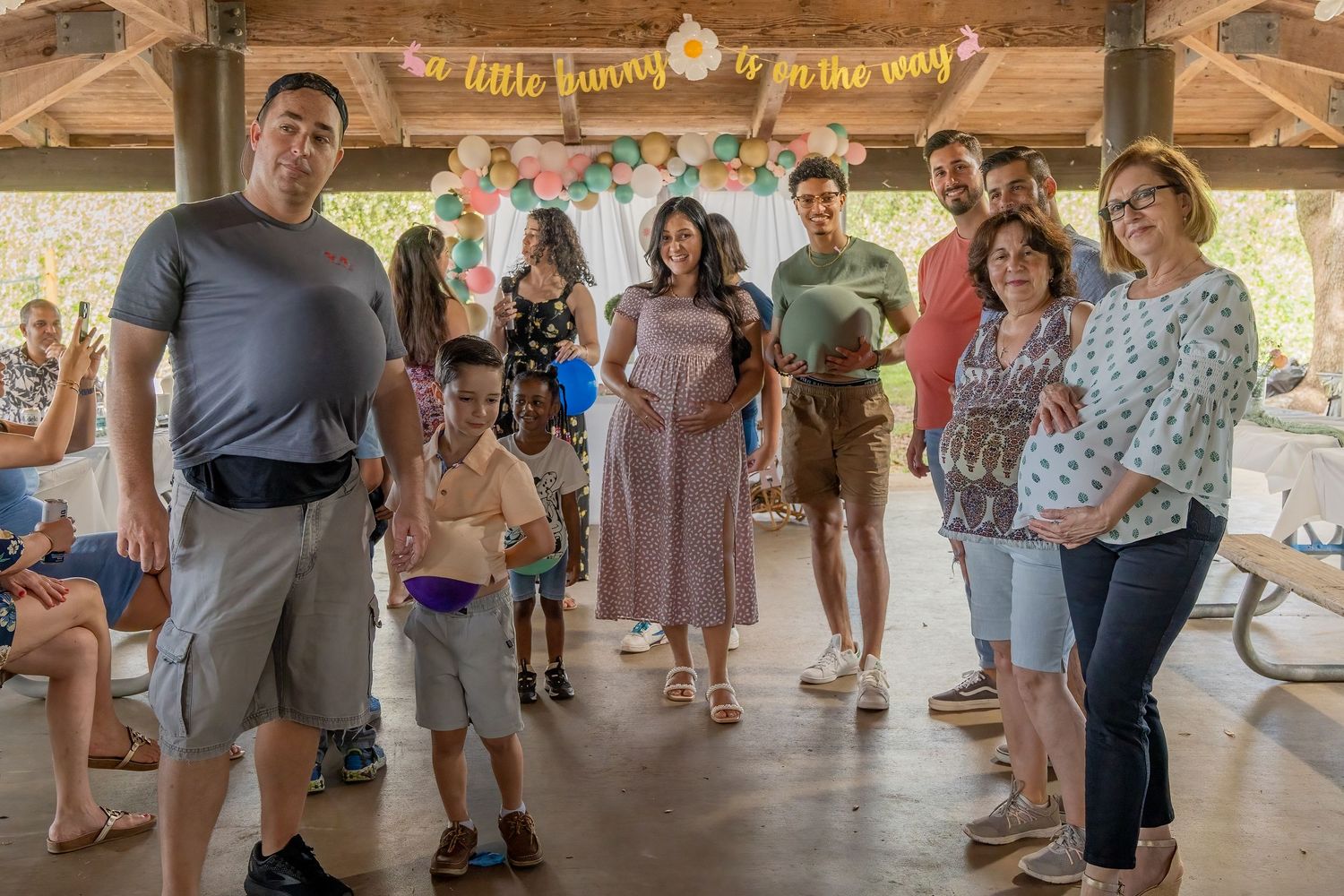Guests standing together inside a pavilion during a South Florida baby shower celebration.