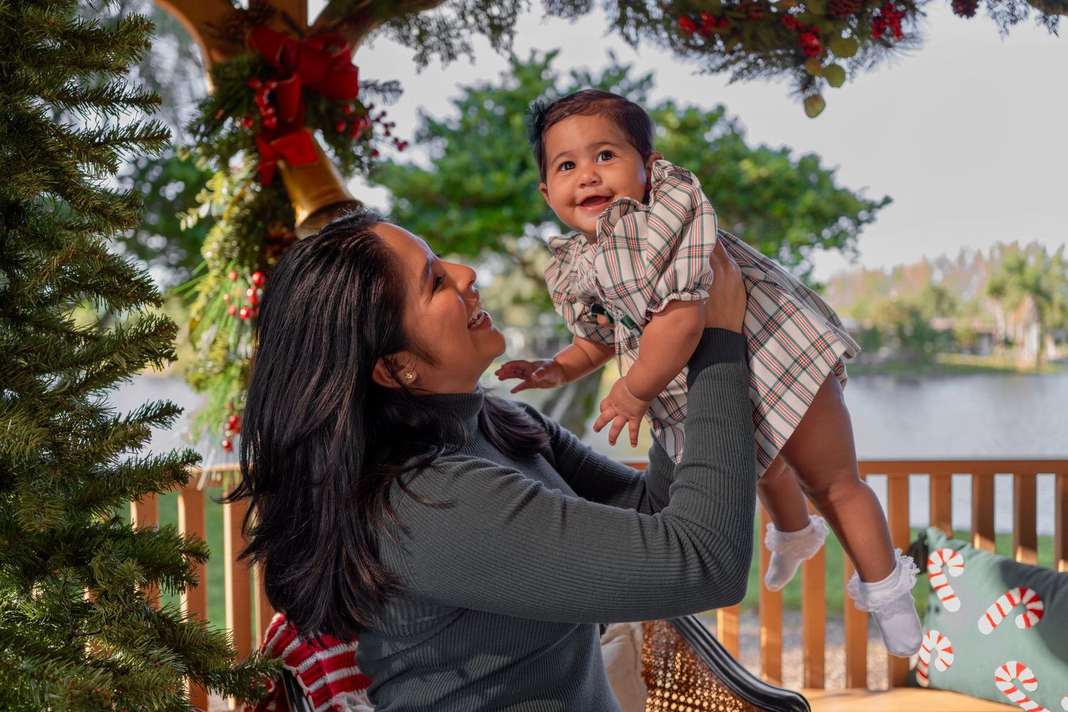 Mother and baby Christmas photoshoot in Pembroke Pines, FL – joyful holiday moment with festive decorations.