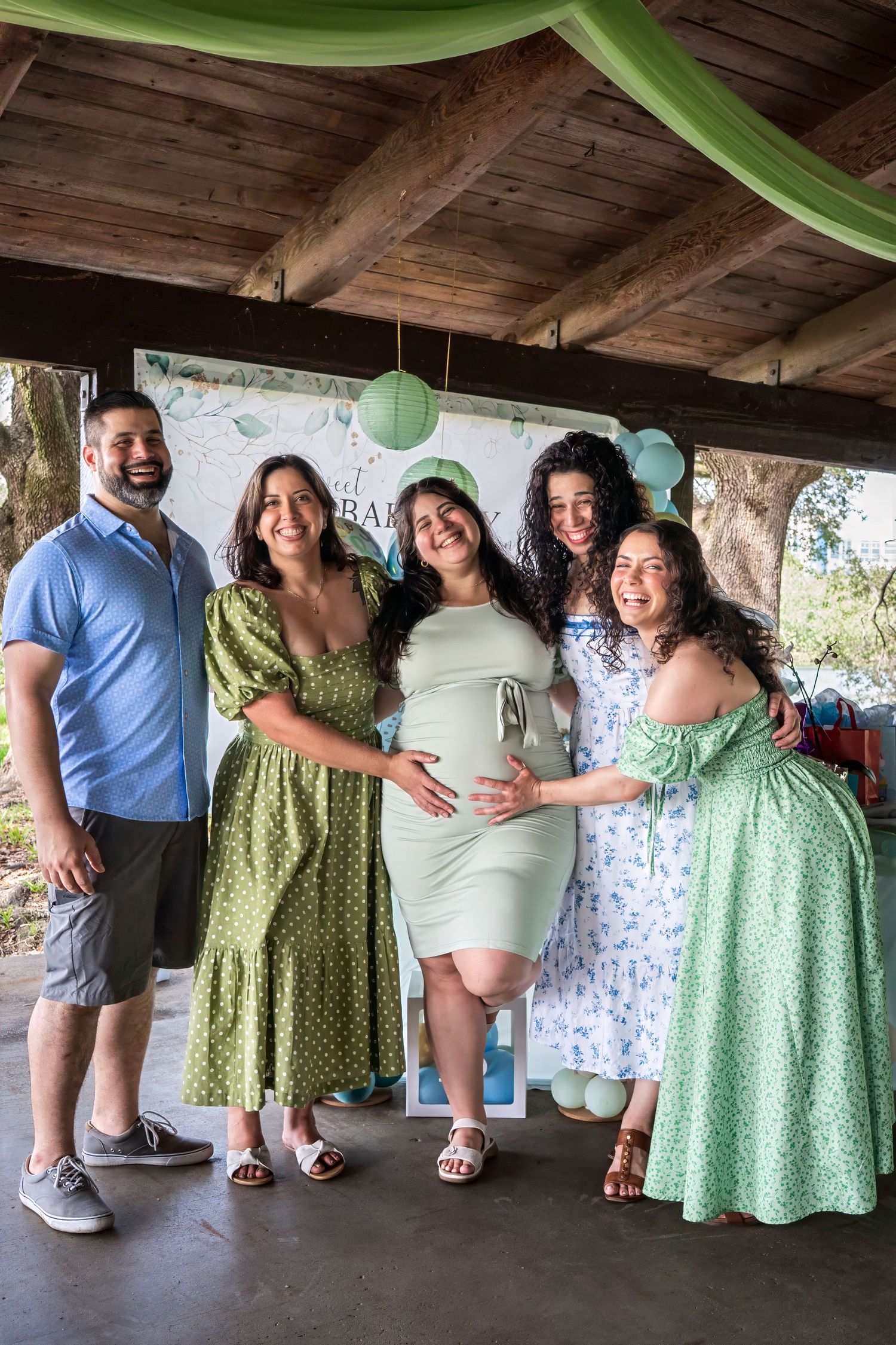 Group of family and friends posing together at an outdoor baby shower celebration in South Florida.