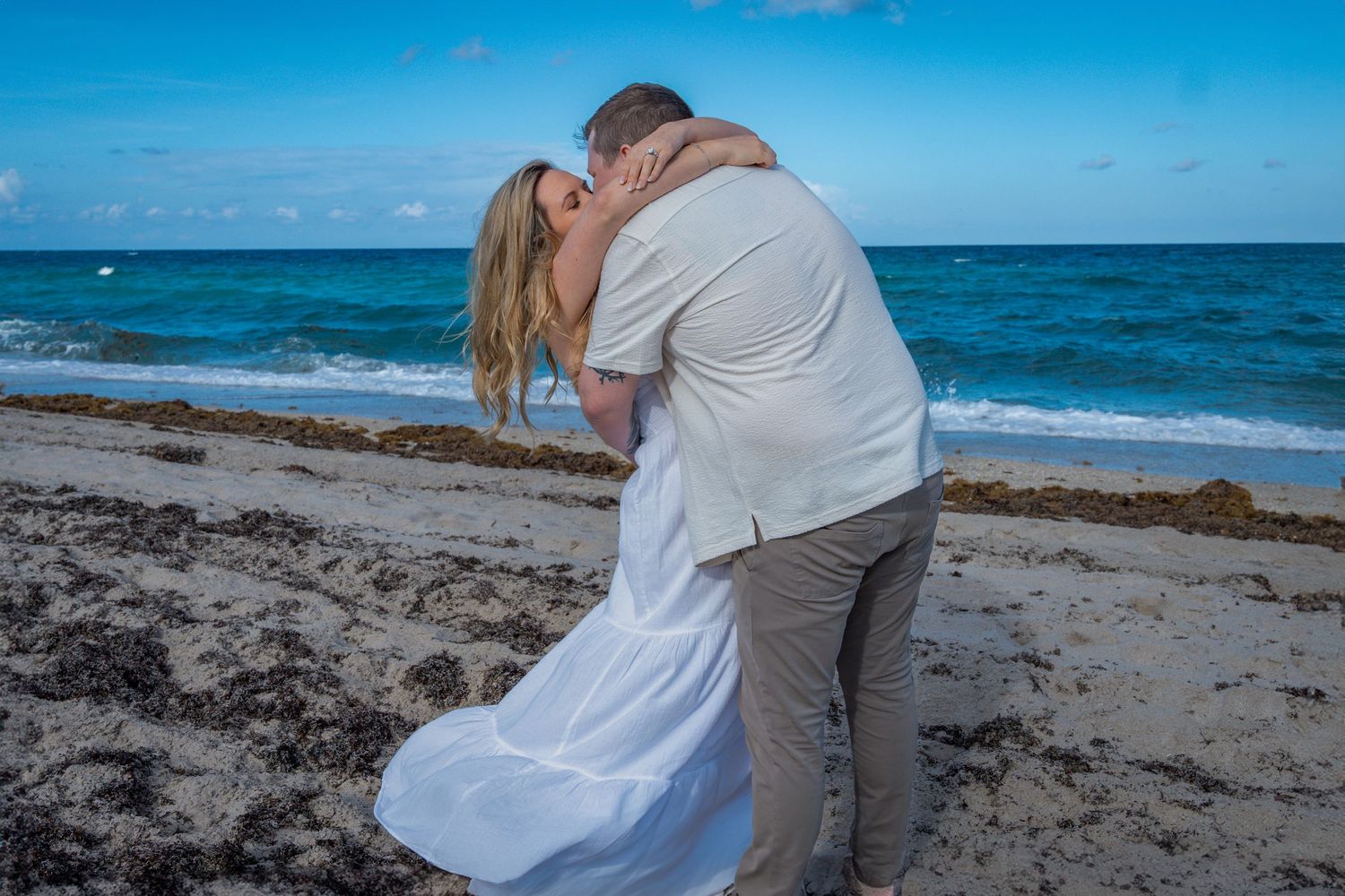 Romantic engagement session on a Florida beach, capturing love, laughter, and celebration.