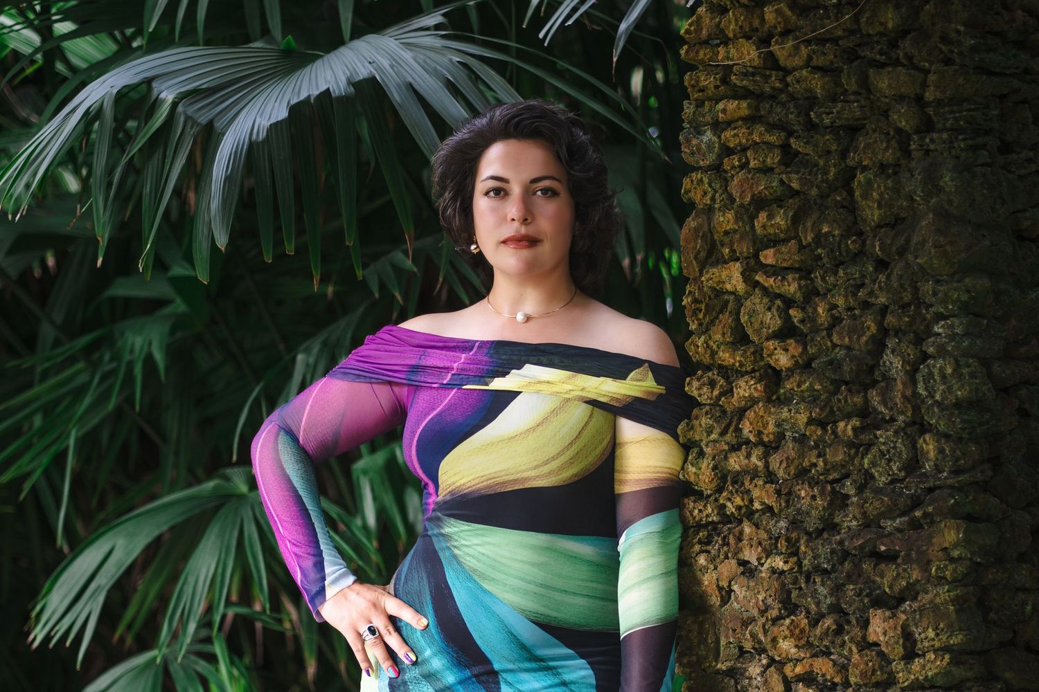 Editorial branding portrait of a woman standing confidently beside palm trees at Fairchild Garden in South Florida.