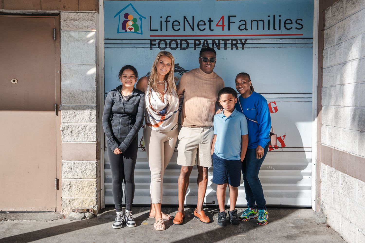 Family portrait taken outside a community space during a Thanksgiving gathering in South Florida.