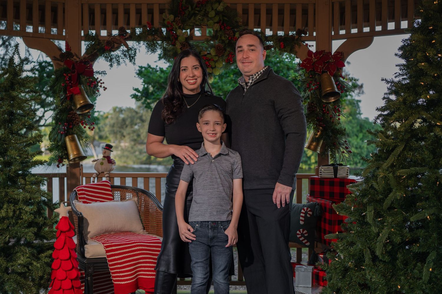 Christmas family mini session in Miami, FL – festive gazebo setup with garlands and lights for a cozy holiday portrait.