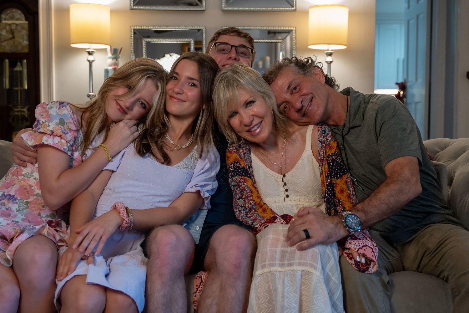 Cozy family portrait in West Palm Beach, FL – multi-generational indoor session with relaxed and happy expressions.