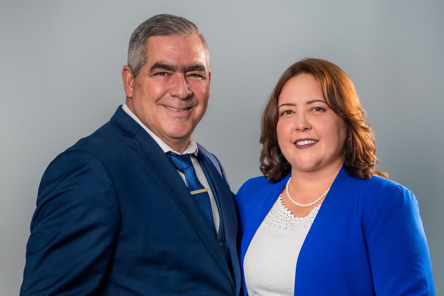 Business couple posing together during studio headshot session