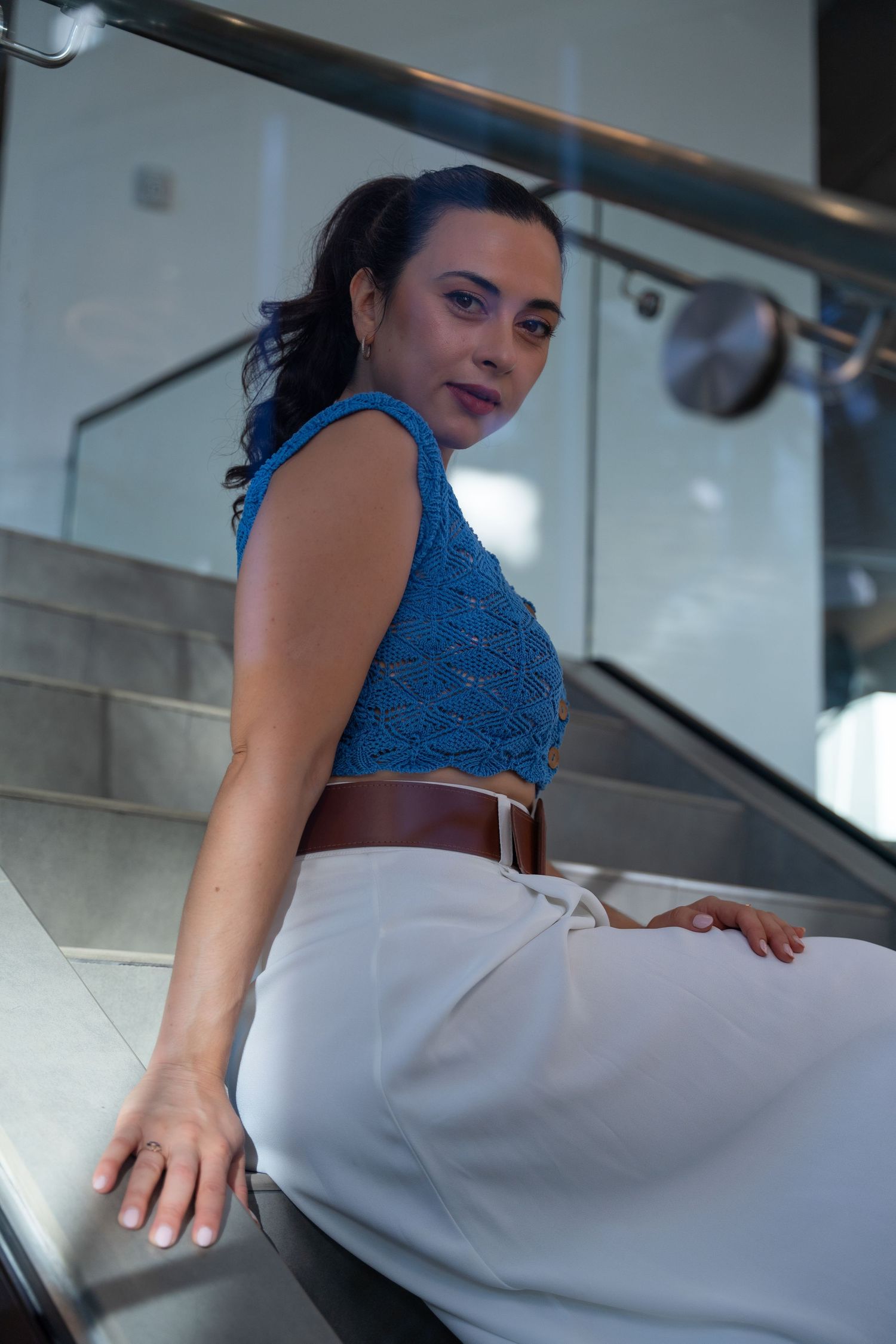 Modern branding portrait in Fort Lauderdale, FL – confident woman posing on a sleek staircase in a professional setting.