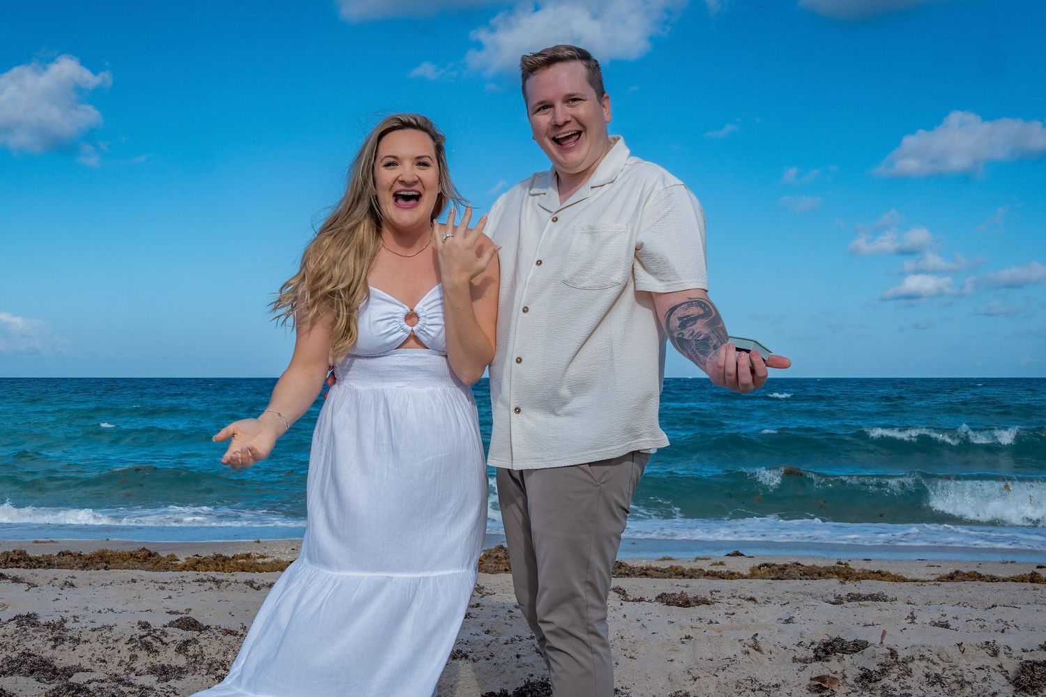 Scenic beach proposal in South Florida, capturing a once-in-a-lifetime moment with the ocean waves behind them.