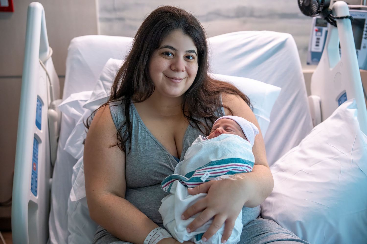 South Florida newborn lifestyle photo of mother holding baby in hospital bed

Lantana Photographer