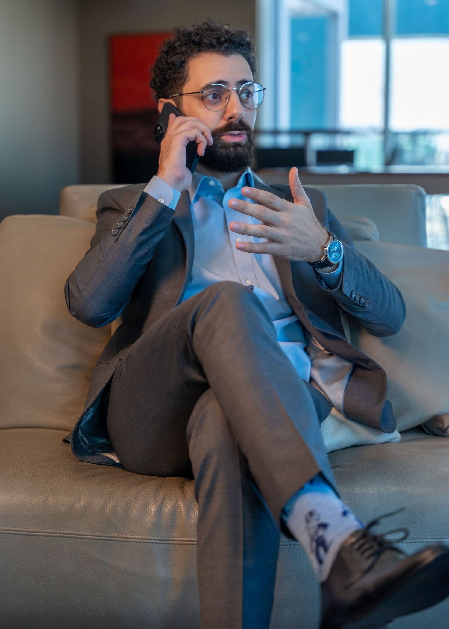 Corporate lifestyle session in West Palm Beach, FL – businessman taking a call in a modern office lounge.