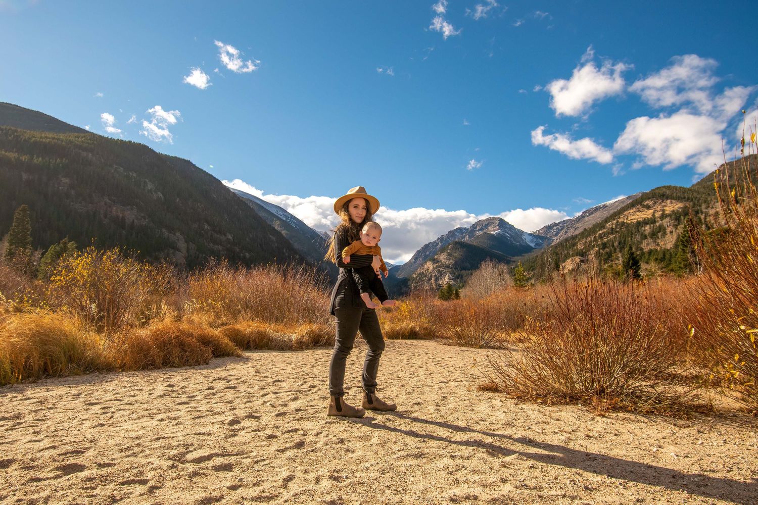 Mountain motherhood session in Breckenridge, CO – mother holding baby with stunning mountain views in the background.