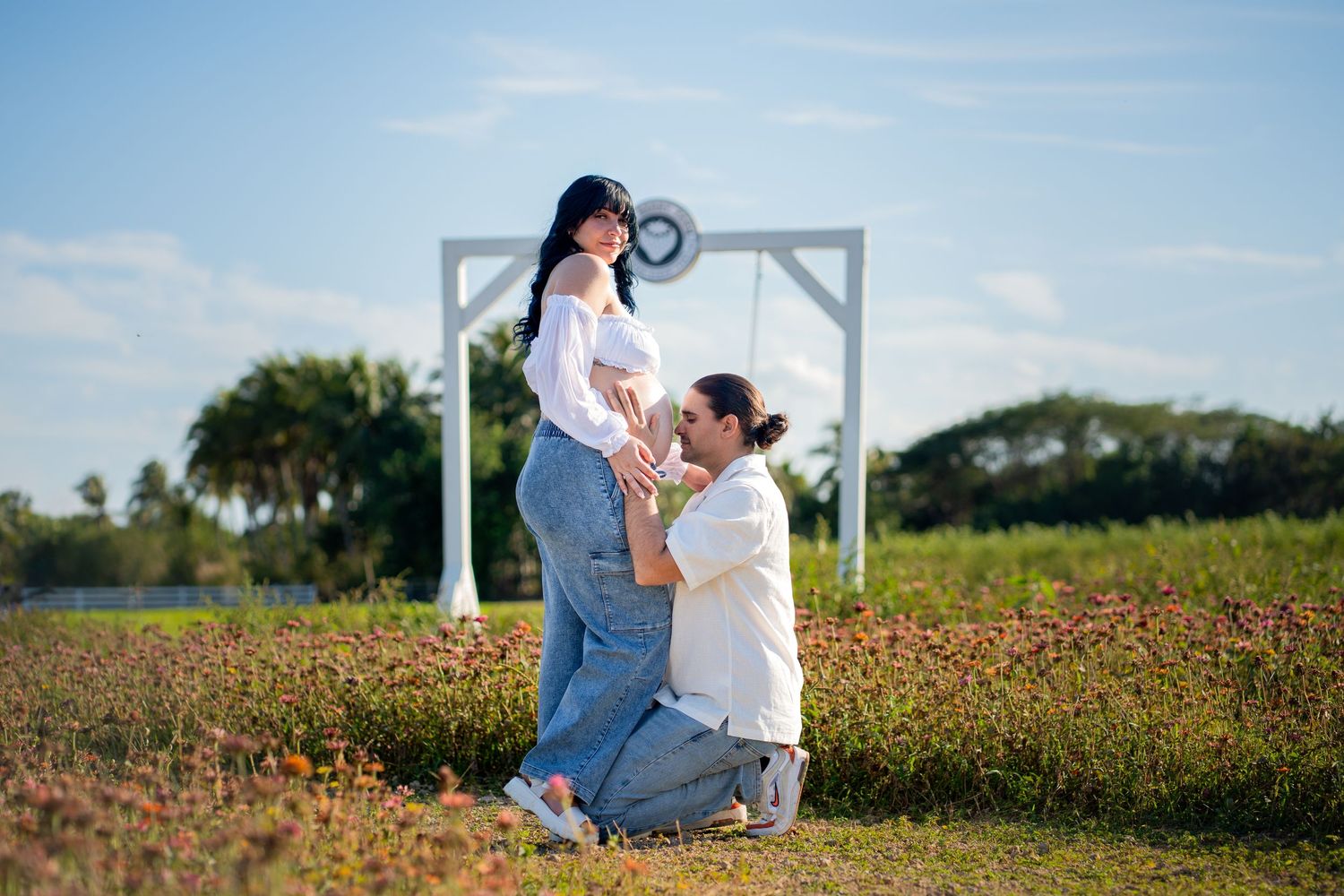 Intimate maternity photo surrounded by sunflowers in South Florida.