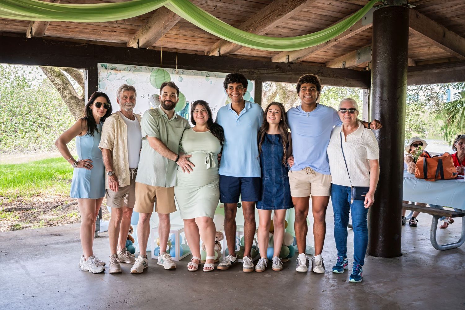 Group portrait of friends and family standing together at a South Florida baby shower event.