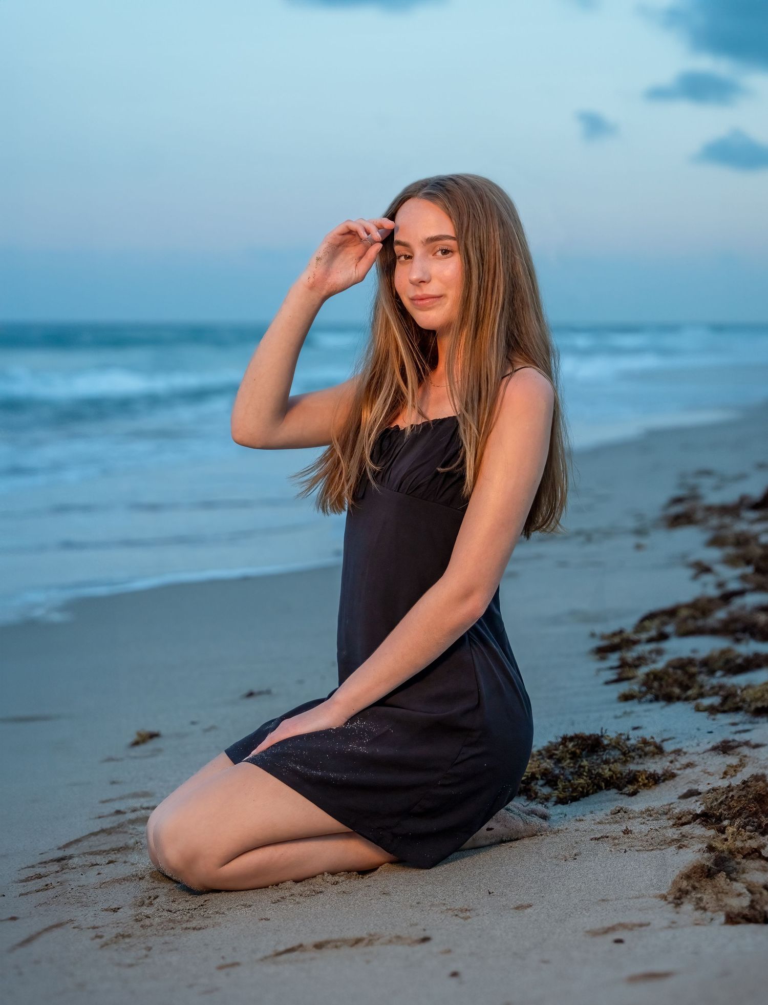 High school senior portrait on the beach in Fort Lauderdale, featuring soft ocean waves and golden light.