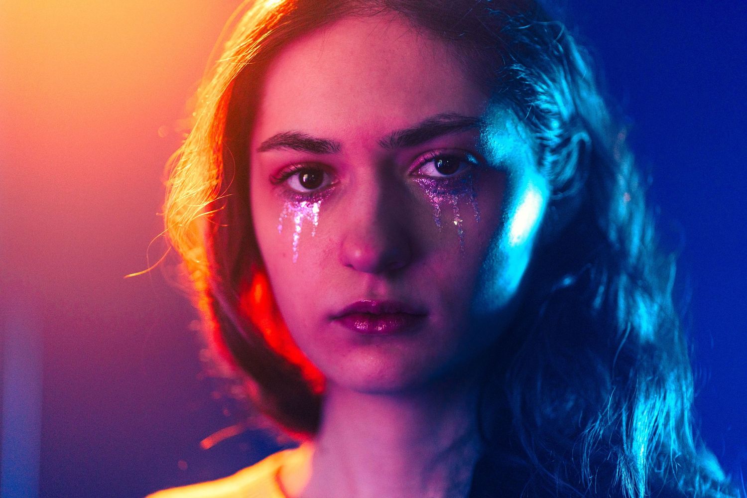 Cinematic neon portrait at a private studio in Miami, FL – dramatic lighting with warm and cool tones for an emotional effect.