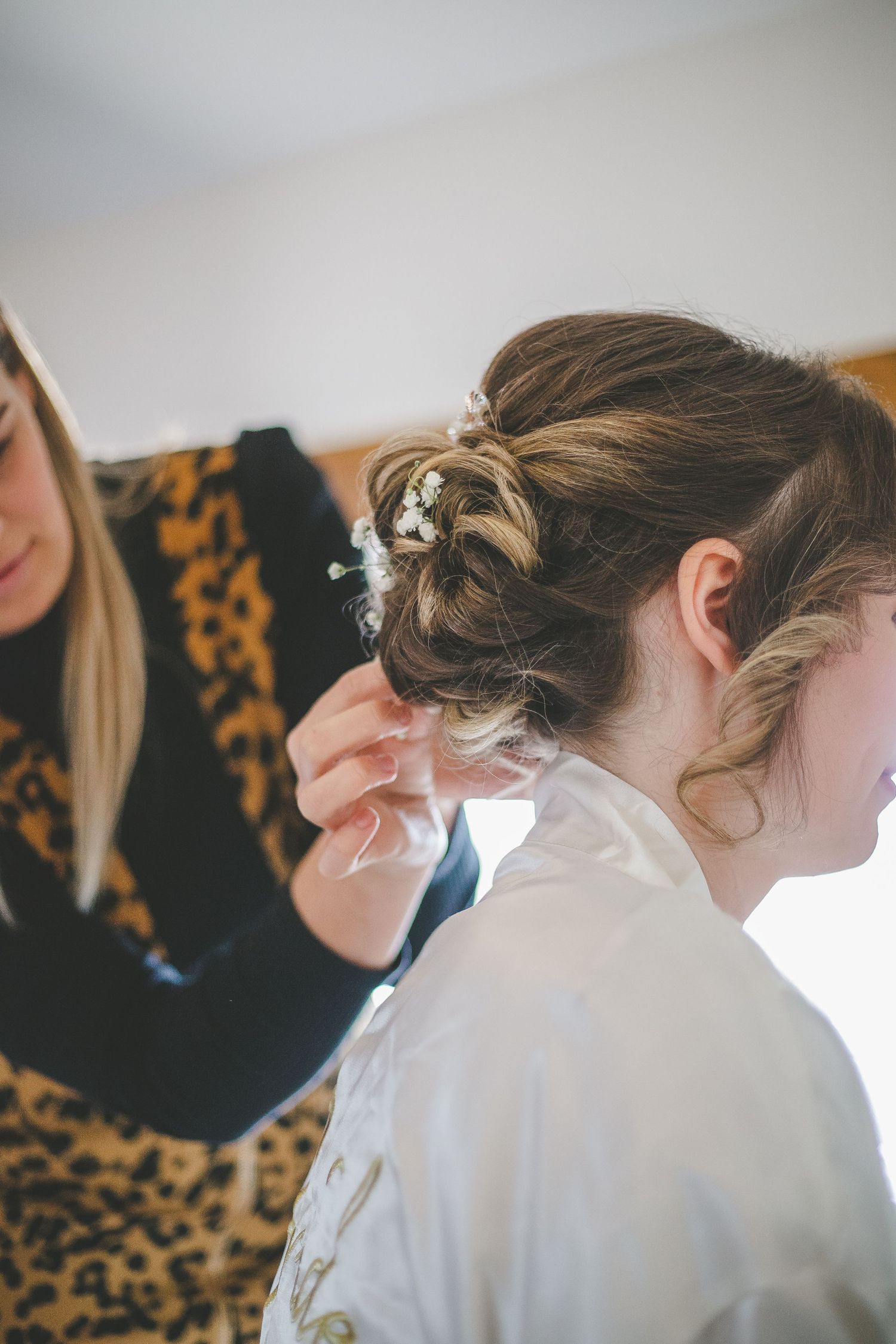 Close-up profile views showing elegant bridal hair styling with delicate pins and curls.