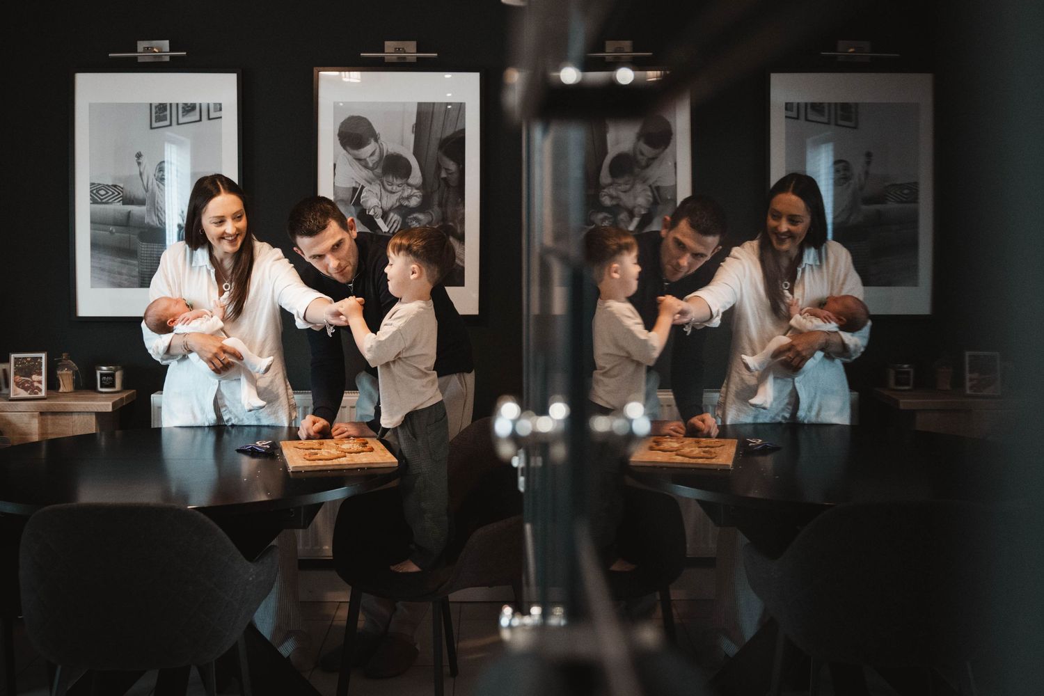 Image in natural environment. At home session showing family moment in kitchen. Real, authentic photograph of family.
