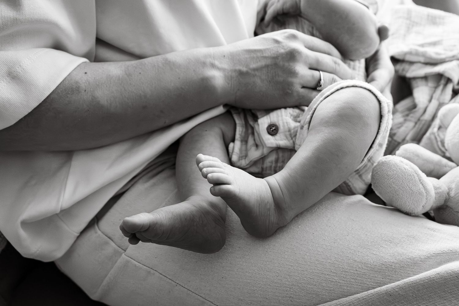 Black and white family photograph of Mother and baby having moment of connection during an at home session in Lincoln, UK