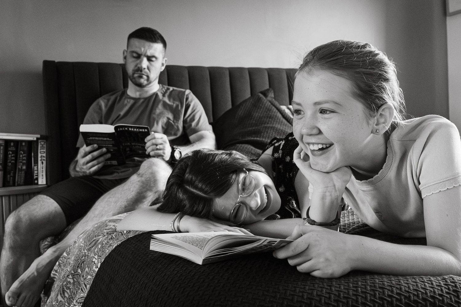 In-the-moment documentary style photograph of father and daughters during at-home session in Lincoln, UK.