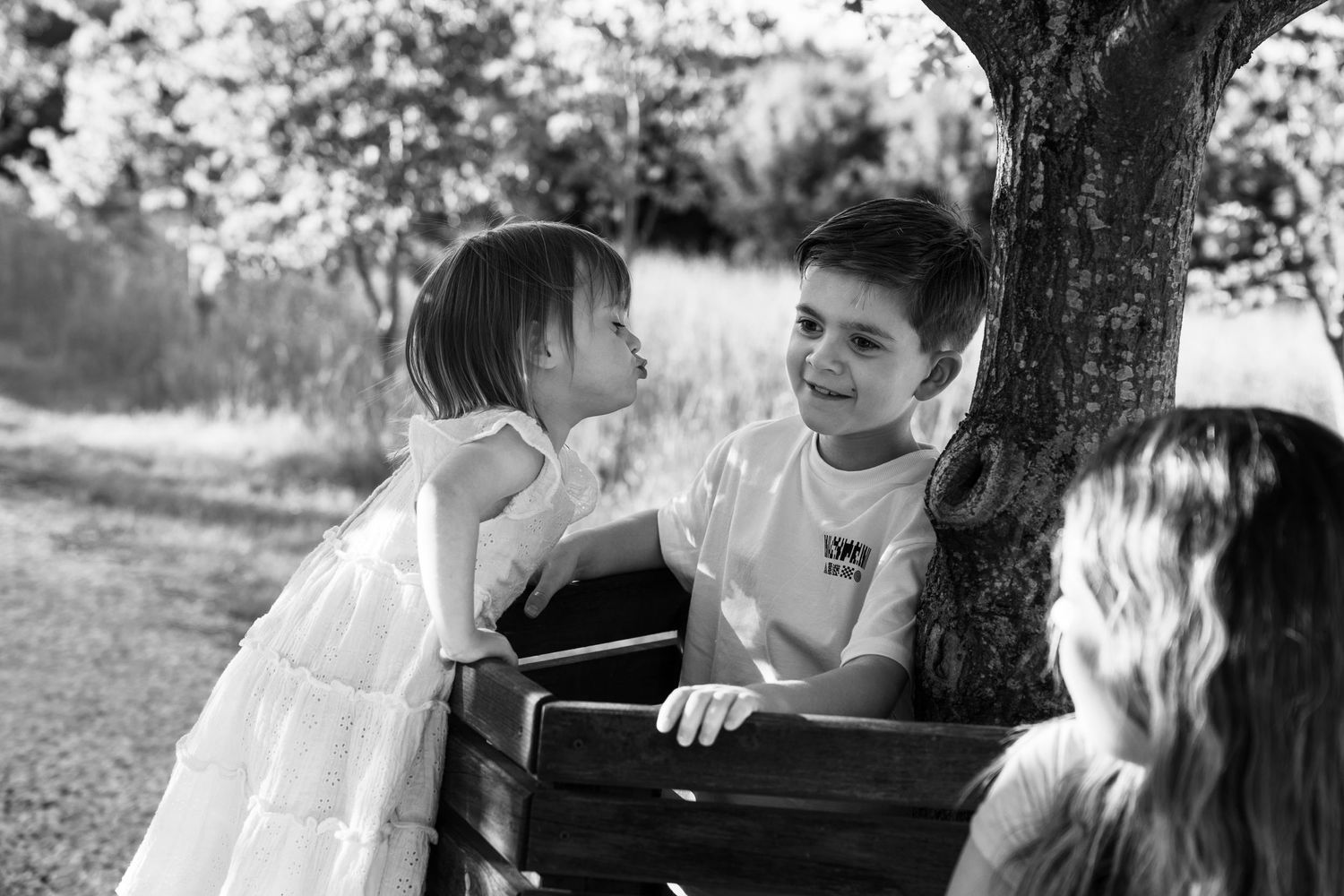 Documentary style black and white family photograph in outdoor location in Lincoln, UK