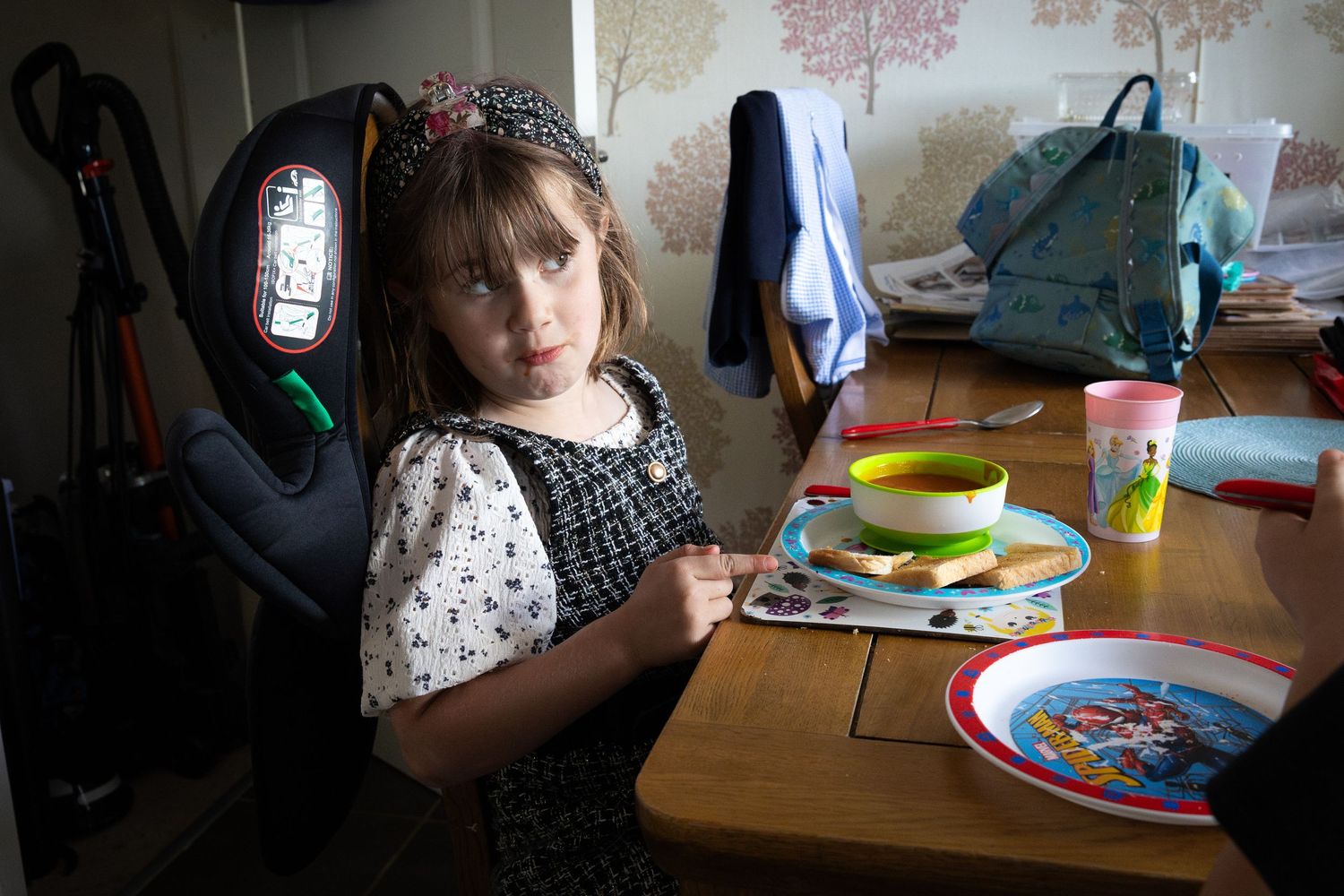 Girl in family home in Lincoln, Lincolnshire. Documentary style image of child at dinner table in real home surroundings.