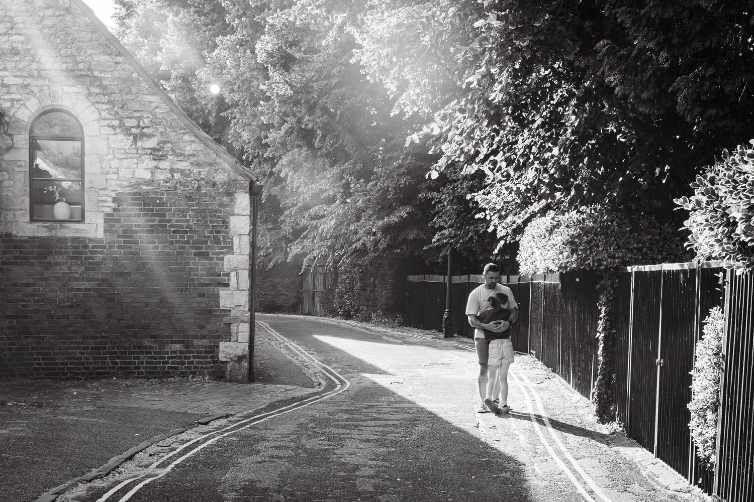 Black and white image of a father and daughter having moment of connection in outdoor location.