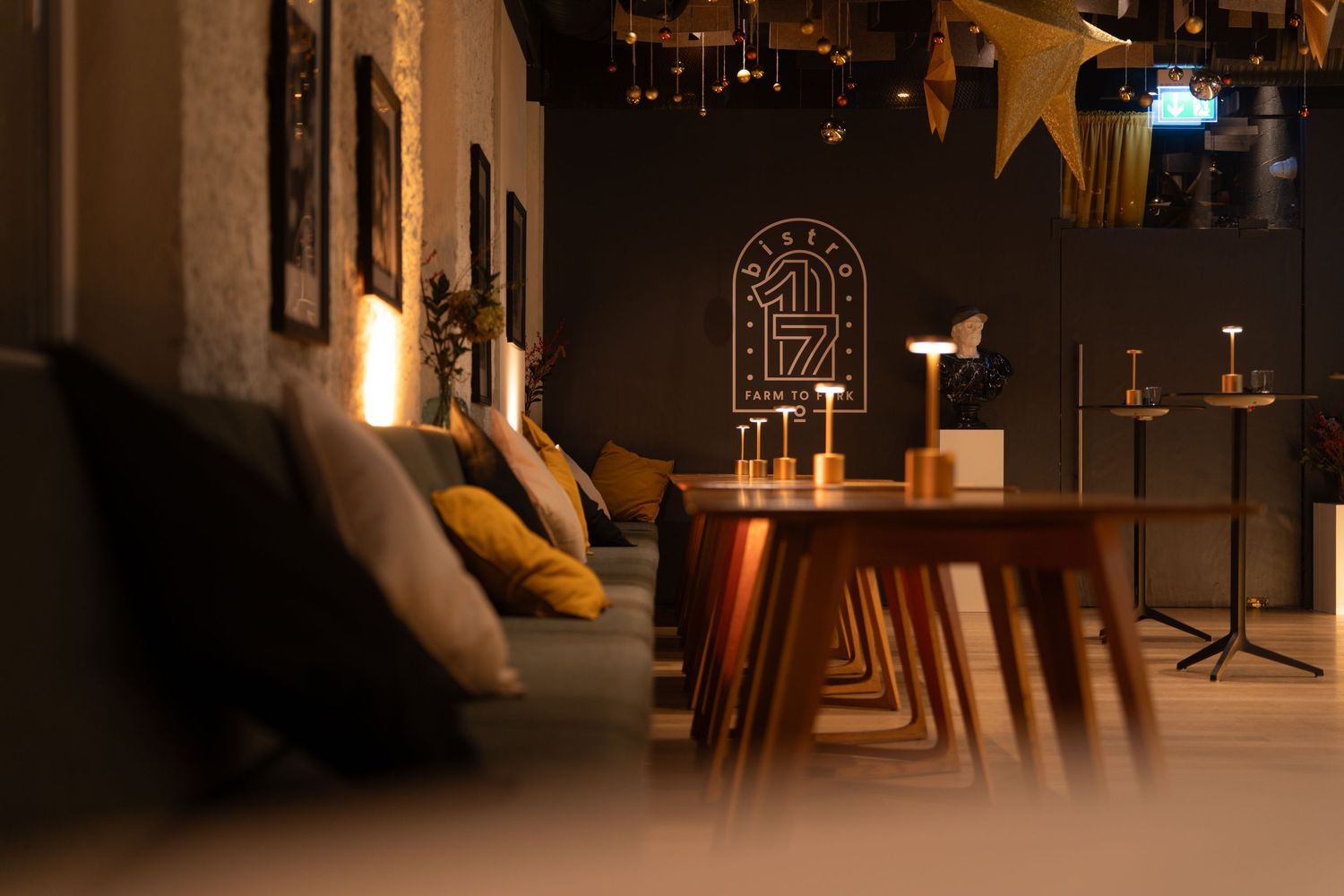 Stylish dark interior lounge with warm lighting and modern wooden furniture.