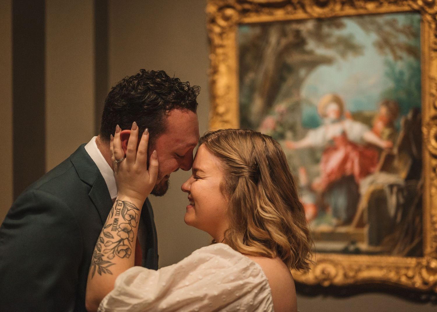 Museum gallery wedding photos with couple dancing among gilded frame artworks.