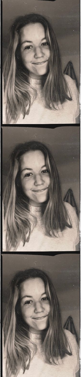 A black and white photo strip showing three similar smiling selfie portraits in a light-colored sweater.