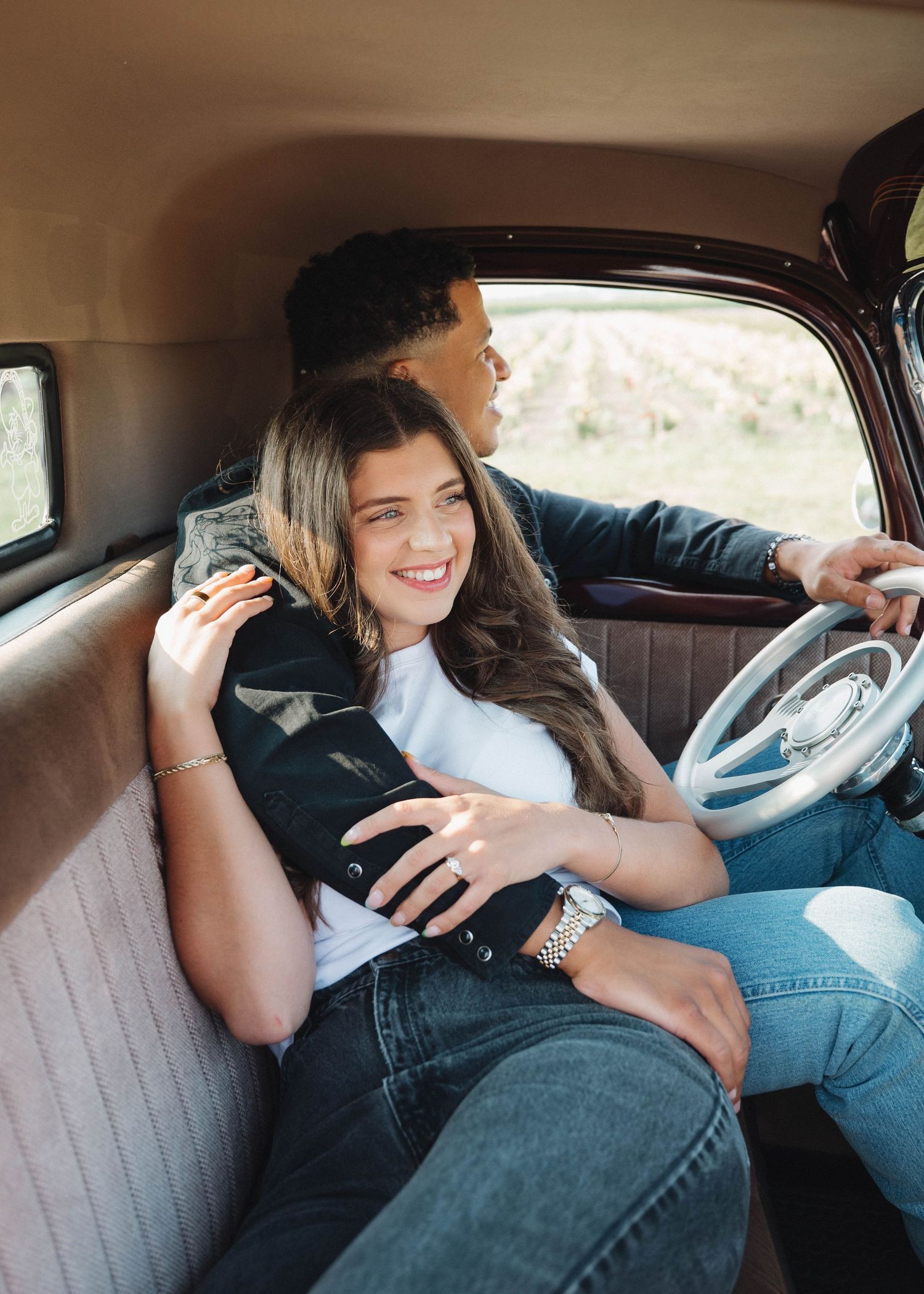 A person sitting in the driver's seat of a vintage car interior showing casual relaxed poses in a photo series.