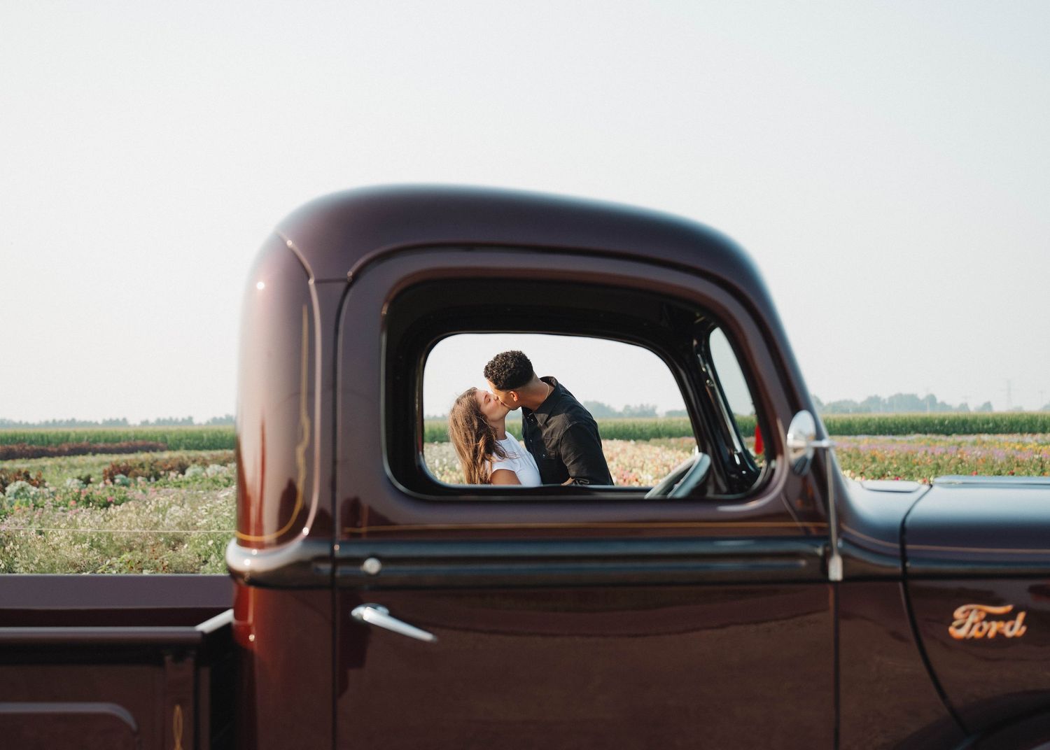 A series of landscape photos showing a vintage brown Ford car against rural countryside backgrounds.