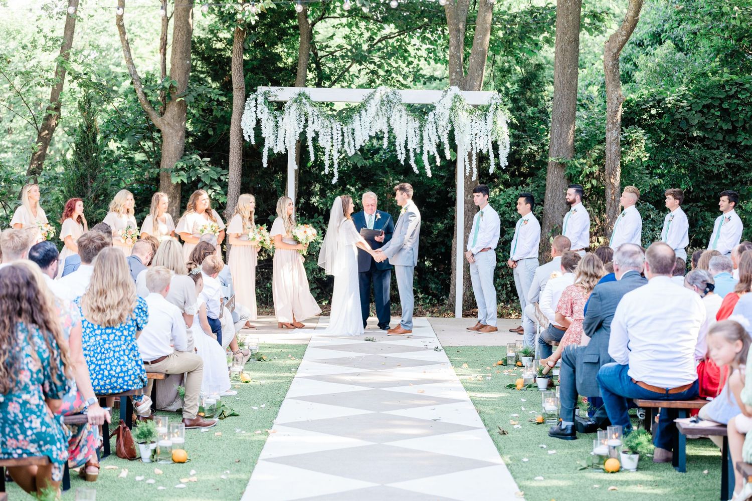 Wide shot of the bride and groom at the alter during the ceremony at the RoseMary Barn.